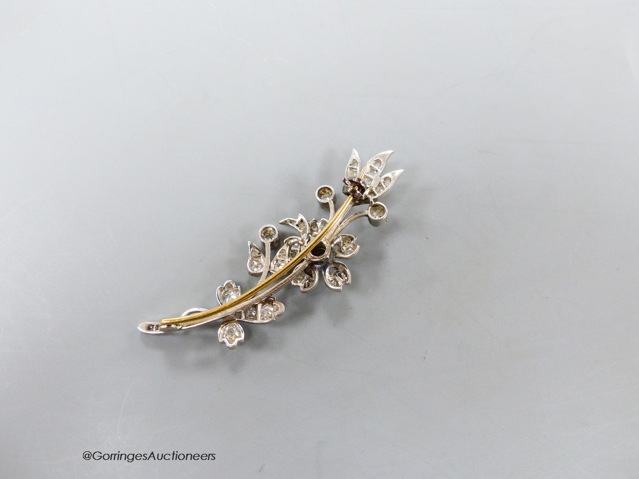 A mid 20th century white metal and diamond set floral spray brooch, 52mm, gross weight 8.3 grams.